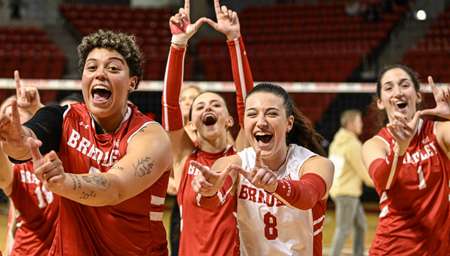 Bradley University volleyball players celebrating on the court.